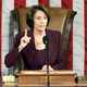 The speaker of the house openly addresses colleagues while wearing lipstick and pantyhose.